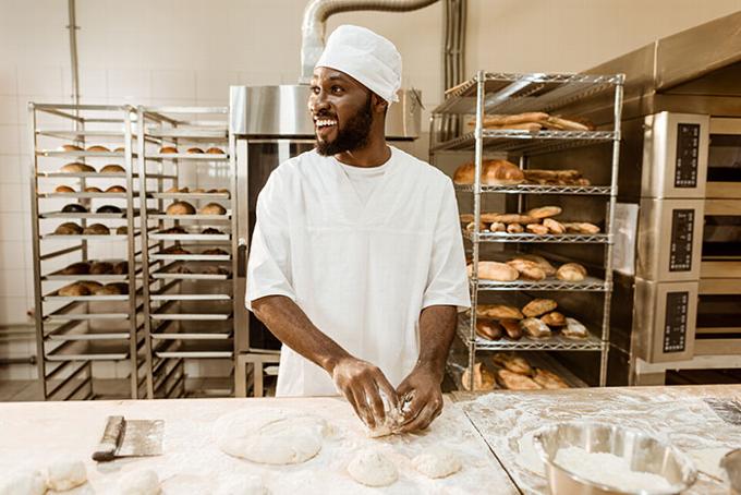 African man baking in commercial kitchen
