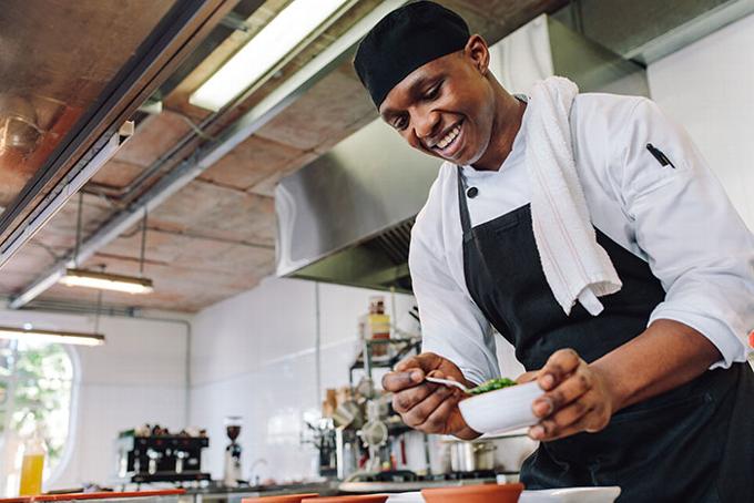 male African chef in professional kitchen